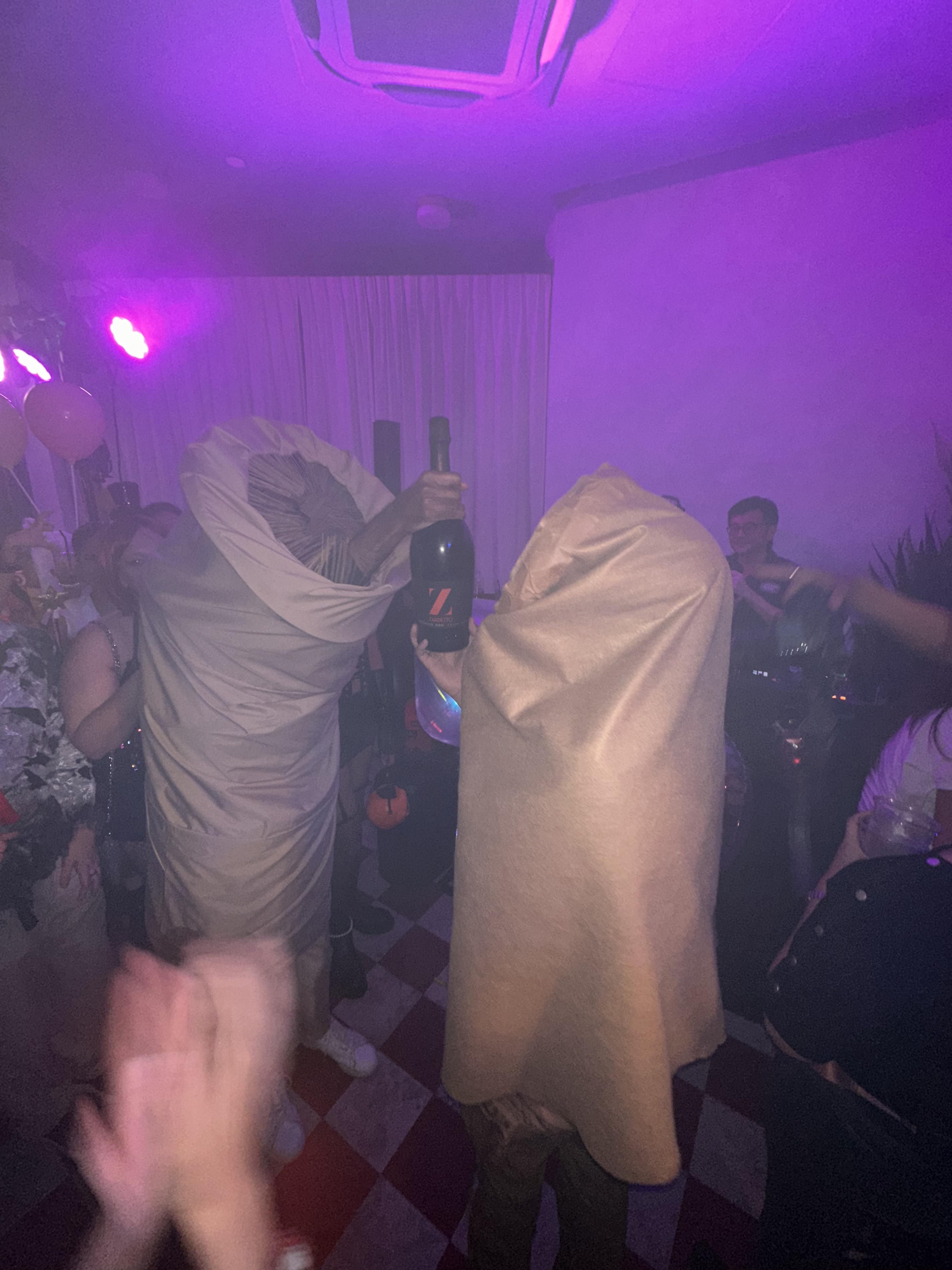 The two worms holding a bottle of prosecco