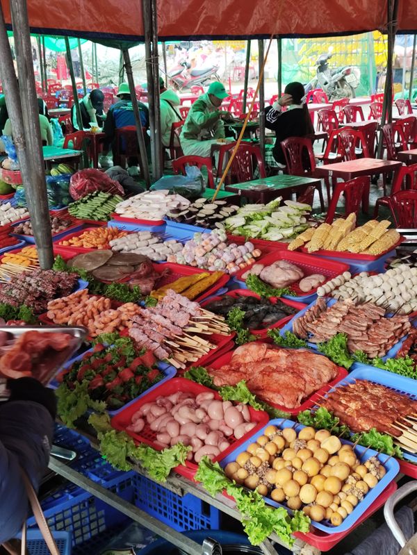 A market stall with tons of food.